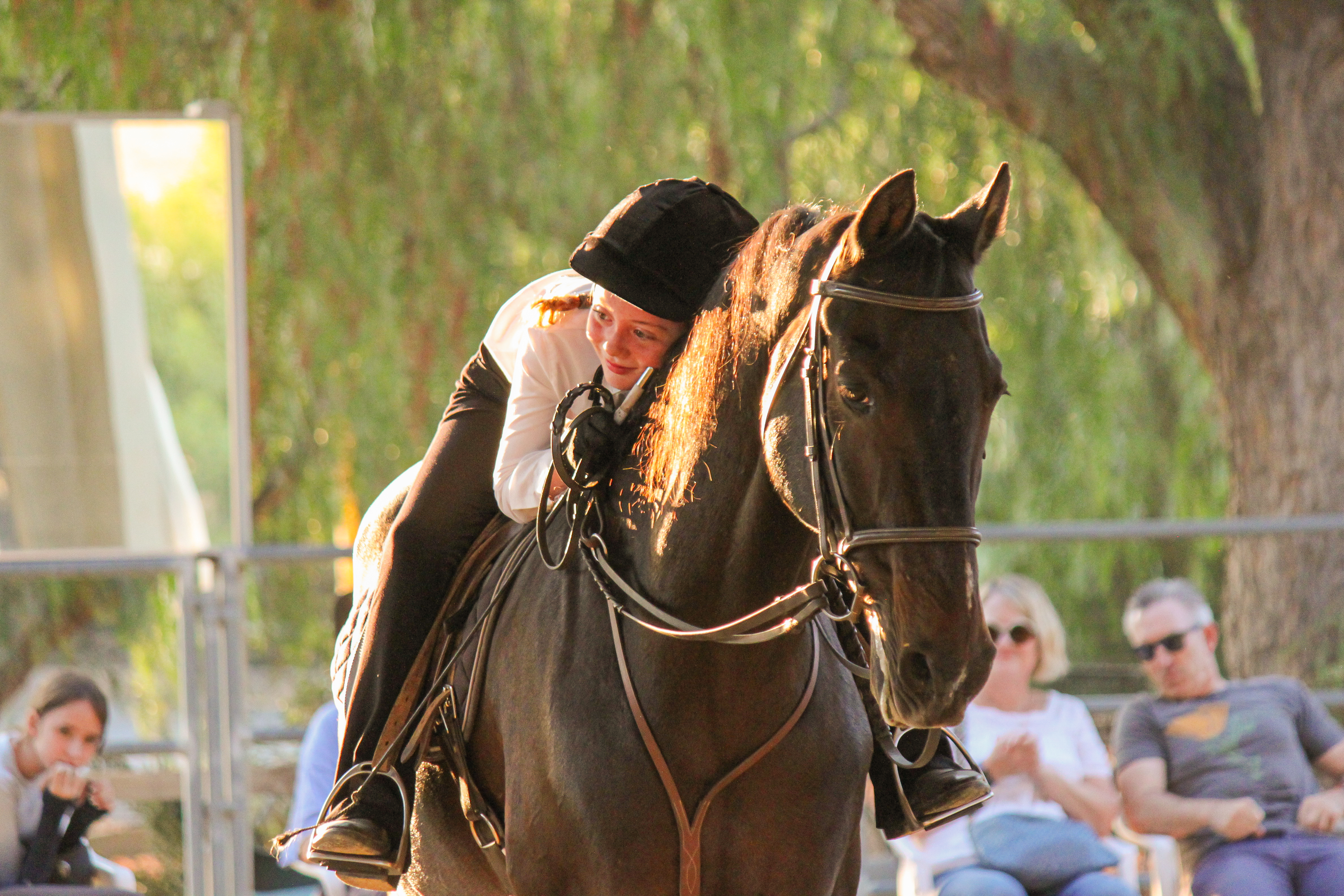 Rider connecting with horse at sunset